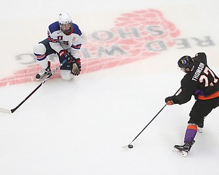 Youngstown Phantoms left wing Matt Thompson (27) moves the puck backwards as Team USA forward Jonathan Gruden (17) leans down to block his shot in the third period of an USHL regular season hockey game, Monday, Jan. 15, 2018, in Youngstown. Team USA won 7-1...(Nikos Frazier | The Vindicator)