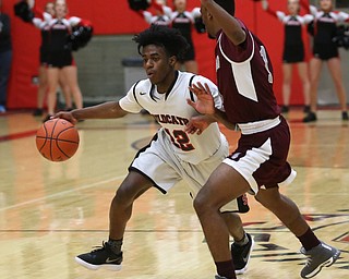 Struthers' Brandon Washington (12) pushes past Boardman guard JaJuantae Young (1) in the second quarter of an AAC high school basketball game, Tuesday, Jan. 16, 2018, in Struthers. Boardman won 71-48...(Nikos Frazier | The Vindicator)