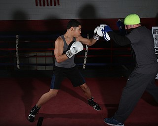 Brayan Colon spars with trainer Vinny O'Neil, Tuesday, Jan. 16, 2018, at the Southside Boxing Gym in Youngstown...(Nikos Frazier | The Vindicator)