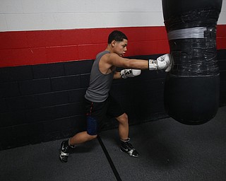 Brayan Colon works the heavy bag, Tuesday, Jan. 16, 2018, at the Southside Boxing Gym in Youngstown...(Nikos Frazier | The Vindicator)