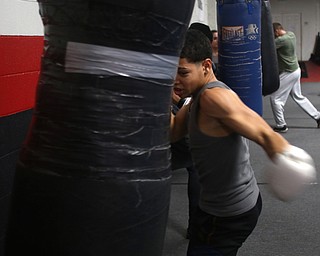 Brayan Colon works the heavy bag, Tuesday, Jan. 16, 2018, at the Southside Boxing Gym in Youngstown...(Nikos Frazier | The Vindicator)