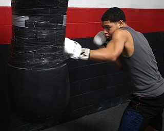 Brayan Colon works the heavy bag, Tuesday, Jan. 16, 2018, at the Southside Boxing Gym in Youngstown...(Nikos Frazier | The Vindicator)