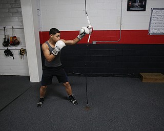 Brayan Colon works the striking bag, Tuesday, Jan. 16, 2018, at the Southside Boxing Gym in Youngstown...(Nikos Frazier | The Vindicator)