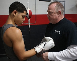 Brayan Colon talks with coach Jack Loew as he cinches up his gloves, Tuesday, Jan. 16, 2018, at the Southside Boxing Gym in Youngstown...(Nikos Frazier | The Vindicator)