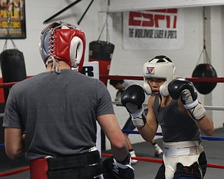 Brayan Colon(white) spars with Carlos Gaerena Morales(red), Tuesday, Jan. 16, 2018, at the Southside Boxing Gym in Youngstown...(Nikos Frazier | The Vindicator)