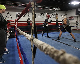 Trainer Vinny O'Neil watches as Brayan Colon(white) spars with Carlos Gaerena Morales(red), Tuesday, Jan. 16, 2018, at the Southside Boxing Gym in Youngstown...(Nikos Frazier | The Vindicator)