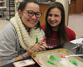 Neighbors | Abby Slanker.Canfield High School juniors Katherine Roman (left) and Brianna Remias (right) created Variegated Disaccharide “J” Tubes, also known as candy canes, in Tom Slaven’s chemistry class on Dec. 22.