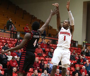 Youngstown State guard Braun Hartfield (1) goes up for three as UIC guard Tarkus Ferguson (4) attempts to block his shot in the first half of a NCAA college basketball game, Thursday, Jan. 18, 2018, in Youngstown. UIC won 92-78...(Nikos Frazier | The Vindicator)