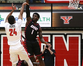 UIC guard Marcus Ottey (1) attempts to block Youngstown State guard Cameron Morse (24)'s three point attempt in the first half of a NCAA college basketball game, Thursday, Jan. 18, 2018, in Youngstown. UIC won 92-78...(Nikos Frazier | The Vindicator)