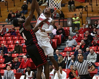 Youngstown State guard Braun Hartfield (1) goes up for a layup against UIC guard Tarkus Ferguson (4) in the first half of a NCAA college basketball game, Thursday, Jan. 18, 2018, in Youngstown. UIC won 92-78...(Nikos Frazier | The Vindicator)