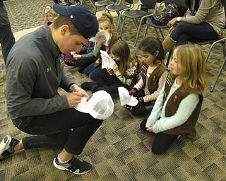 Neighbors | Zack Shively.Upon arriving, the children received free hats with the Phantom logo on it. The parents were given tickets for the whole family to see the Phantoms play on Jan. 15. Pictured, Gianfranco Cassaro autographed a hat for a child.