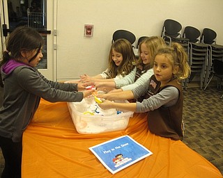 Neighbors | Zack Shively.After the story time, the children could play games and make crafts in the meeting room. The Austintown librarians set up the games, such as the one pictured that allowed the children to play in fake snow.