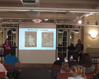 Neighbors | Zack Shively.Rose and Freddie Seitz gave a presentation on Freddie's life growing up with facial differences on Jan 11 at the Poland library. Rose Seitz talked about his surgeries, graduations and love. During her portion of the presentation, she spoke behind the podium and controlled the slideshow while librarian Karen Steed, left, interpreted her presentation into ASL.