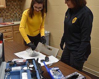 Neighbors | Submitted.Detective Sergeant Kathy Dina mentors Kaylee Aliberti in the Community Connectors program. Dina has shown Aliberti labs and some crime scenes. Aliberti is interested in criminal justice with a focus on forensics. Pictured, Dina taught Aliberti how to dust for fingerprints and pull prints for identification.