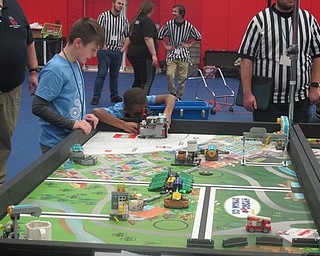 Neighbors | Zack Shively.Teams spent two and half minutes to solve a series of tasks using their robots. Pictured, Zach and Isaiah of the Aquanauts set up their robot.