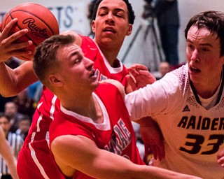 LaBrae #20 Benton Tennant and #21 Tyler Stephens; South Range #33 Brady White; trying to get possession of loose ball