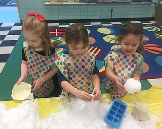 Mrs. Conti’s preschool enrichment class brought some snow inside during a recent in-class snow day. The children built snow men and did various science experiments. Above, from left, are Claire Keating, Sylvie Sylvester and Lyla Sam.
