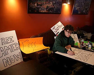 Nick Adduci of Hubbard creates a protest sign before marching in support of Al Adi to the Nathaniel R. Jones Federal Building & U.S. Courthouse, Saturday, Jan. 20, 2018, at Downtown Circle in Youngstown...(Nikos Frazier | The Vindicator)