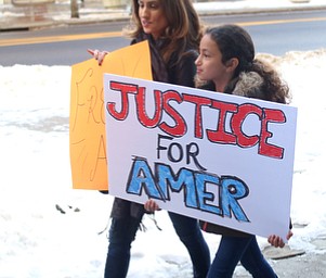 Gina Musluh of Boardman marches with her daughter, Mia(9) in support of Al Adi to the Nathaniel R. Jones Federal Building & U.S. Courthouse, Saturday, Jan. 20, 2018, at Downtown Circle in Youngstown...(Nikos Frazier | The Vindicator)