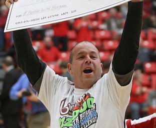 Bill Cupler celebrates after his half court shot won him $12,000 from Burgan Real Estate during a media timeout at an NCAA college basketball game between YSU and IUPUI, Saturday, Jan. 20, 2018, in Youngstown...(Nikos Frazier | The Vindicator)