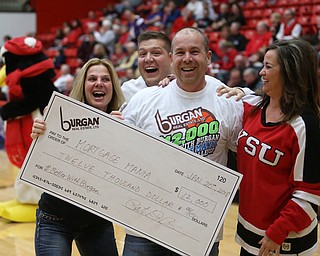 Bill Cupler(center) and wife, Natalie(left) celebrate after his half court shot won them $12,000 from Burgan Real Estate during a media timeout at an NCAA college basketball game between YSU and IUPUI, Saturday, Jan. 20, 2018, in Youngstown...(Nikos Frazier | The Vindicator)