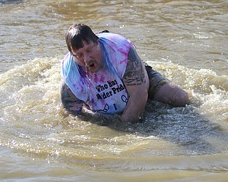 Warren Police Officer Mike Currington, a school resource officer at Warren Harding, participates in the annual Polar Bear Plunge in mid 30 degree water for the Special Olympics, Saturday, Jan. 20, 2018, at the Mosquito Lake State Park Swimming Beach in Cortland...(Nikos Frazier | The Vindicator)