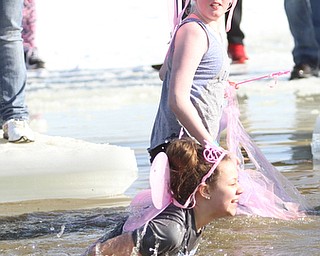 Caroline Mahon(11)(top) watches her friend, Rowan Rotonda(11) take the dip as they participate in the annual Polar Bear Plunge in mid 30 degree water for the Special Olympics, Saturday, Jan. 20, 2018, at the Mosquito Lake State Park Swimming Beach in Cortland...(Nikos Frazier | The Vindicator)
