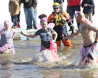 Chris Rotonda looks back at his daughter, Rowan Rotonda(11)(Center) and her friend, Caroline Mahon(11) participate in the annual Polar Bear Plunge in mid 30 degree water for the Special Olympics, Saturday, Jan. 20, 2018, at the Mosquito Lake State Park Swimming Beach in Cortland...(Nikos Frazier | The Vindicator)
