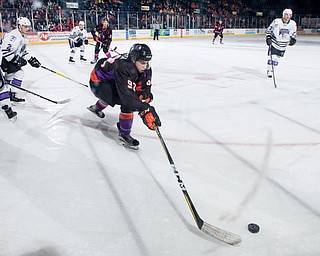 Scott R. Galvin | The Vindicator.Youngstown Phantoms center Alexander Barber (92) reaches for the puck along the board during the first period against the Tri-City Storm at the Covelli Centre on Saturday, January 20, 2018. The Phantoms lost 2-1 in overtime.