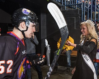 Scott R. Galvin | The Vindicator.Youngstown Phantoms left wing Craig Needham (52) fist bumps Miss Ohio USA 2018 Deneen Penn as he takes the ice for the third period against the Tri-City Storm at the Covelli Centre on Saturday, January 20, 2018.  The Phantoms lost 2-1 in overtime.