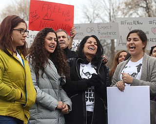 Al Adi's family, daughters; Rania(left), Lana(center left) and  Lina Adi(right) and wife Fidaa Musleh laugh as protestors chant "ICE ain't nice" at a protest rally demanding the release of Al Adi, Sunday, Jan. 21, 2018, outside the Northeast Ohio Correctional Facility in Youngstown...(Nikos Frazier | The Vindicator)