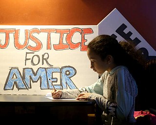 Mia Musleh(9) of Boardman writes a letter to Al Adi, Monday, Jan. 22, 2018, at Downtown Circle in Youngstown...(Nikos Frazier | The Vindicator)