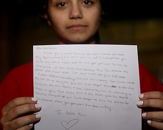 Rameen Musleh(16) holds a letter she wrote to her uncle Al Adi, Monday, Jan. 22, 2018, at Downtown Circle in Youngstown...(Nikos Frazier | The Vindicator)