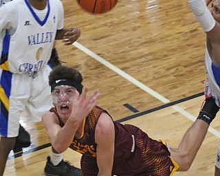 Brandon Youngs (23) of South Range throws up a wild shot while being defended by Valley Christians Emmanuel Armour (0) during the second half of Tuesday nights matchup at Valley Christian School in Youngstown.   Dustin Livesay  |  The Vindicator  1/23/18  Valley Christian.