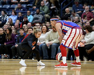 Michelinn Wayt(9) of Warren tries to get the ball from Globetrotter the shot, Jan. 24, 2018, at the Covelli Centre in Youngstown...(Nikos Frazier | The Vindicator)