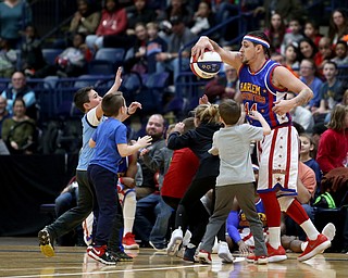 Globetrotter the shot keeps the ball away from a group of kids, Jan. 24, 2018, at the Covelli Centre in Youngstown...(Nikos Frazier | The Vindicator)