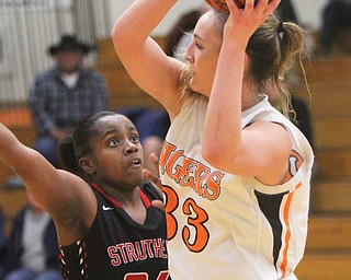 William D. Lewis The Vindicator  Newton Falls Isabelle Kline (33) keeps the ball from Struthers Keasia Chism(34)) during 1-24-18 action at Falls