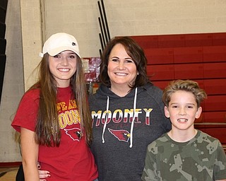 Neighbors | Submitted .Pictured are Petty’s daughter Magen (CMHS ’20), Raynae Petty, Petty’s Widow, with son William (CMHS ’24) during the second annual Cardinal Mooney Alumni basketball game.