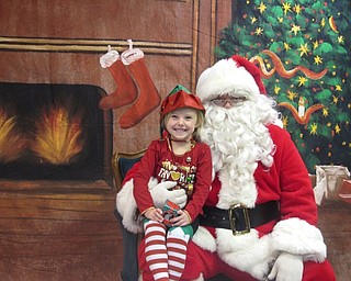 Neighbors | Zack Shively.Austintown Bounce had its Lunch with Santa holiday celebration on Dec. 16. Children could take pictures with Santa at the event. Pictured is Kaydence Nutter posing with Santa.
