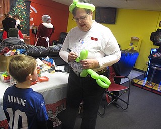 Neighbors | Zack Shively.Gloria Siegfried of The Laughing Ladybug made balloon animals for children at Austintown Bounce's holiday party. The Laughing Ladybug helps support Siegfried’s daughter’s fight against cancer.