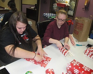 Neighbors | Zack Shively.Home Instead Senior Living brought in approximately 70 volunteers to help wrap thousands of gifts for senior citizens throughout the area. Pictured are, from left, Brianna Weider and Briana Hughes wrapping presents.