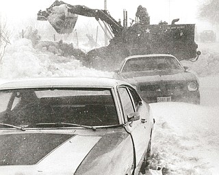 1978 Blizzard     Bob Cook of the National Guard uses a payloader to clear snow on County Line Rd.