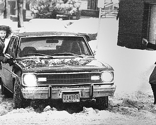 1978 Blizzard  Extricating their car from a snow drift at Lakeside and Mahoning Ave in Youngstown are YSU students Linda Joseph, Sheri Jakubek and Tyna Chance.