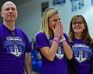 POLAND, OHIO - JANUARY 26, 2018: Lakeview student Alexis Rygalski reacts after hearing the total of the money raised for her treatment while standing not he court with her parents Hope and Mike Rygalski during the second half between Lakeview and Poland on Friday night at Poland High School. DAVID DERMER | THE VINDICATOR