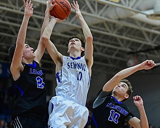 POLAND, OHIO - JANUARY 26, 2018: Poland's Daniel Kramer, center, goes to the basket against Lakeview's Jeff Remmick and AJ McClellan, right, during the second half of their game on Friday night at Poland High School. DAVID DERMER | THE VINDICATOR