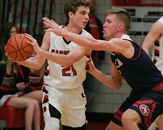 William D. Lewis the Vindicator   Canfield's Zach Tinkey(21)) drives around Fitch's Cole Constance(5) during 1-26-18 action at Canfield.