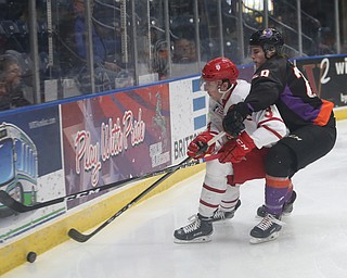 Youngstown Phantoms center Curtis Hall (20) reaches around Dubuque Fighting Saints defenseman Matt Stoia (3) for the puck in the first period of an USHL Hockey game, Sunday, Jan. 28, 2018, in Youngstown. Phantoms won 2-1...(Nikos Frazier | The Vindicator)