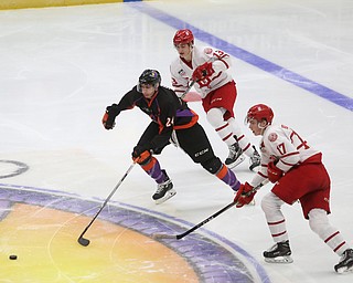 Youngstown Phantoms defenseman Steve Holtz (24) skates towards the puck against Dubuque Fighting Saints forward Tyce Thompson (17) and Dubuque Fighting Saints forward Logan Pietila (13) in the second period of an USHL Hockey game, Sunday, Jan. 28, 2018, in Youngstown. Phantoms won 2-1...(Nikos Frazier | The Vindicator)