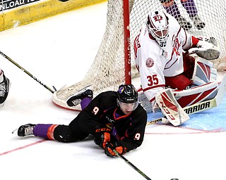 Youngstown Phantoms forward Tommy Parottino (9) attempts to hook the puck past Dubuque Fighting Saints goalie Cole Weaver (35) in the second period of an USHL Hockey game, Sunday, Jan. 28, 2018, in Youngstown. Phantoms won 2-1...(Nikos Frazier | The Vindicator)