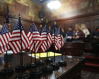 Flags sit on a table during a naturalization ceremony, Thursday, Jan. 24, 2018, at the Mahoning County Courthouse in Youngstown...(Nikos Frazier | The Vindicator)